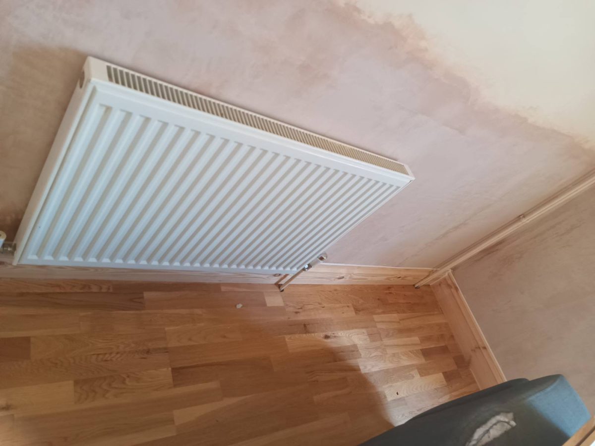 Wall re-plastered with the radiator removed for access